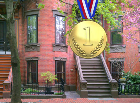 gold medal says number 1 in front of a historic brick townhouse with green leaves of a tree
