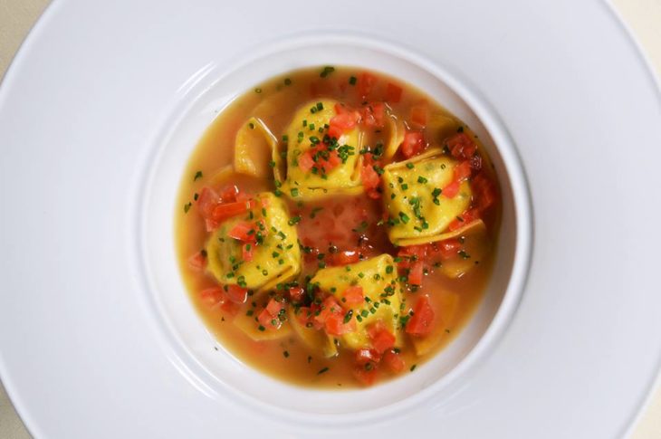 bowl with four pasta dumplings in broth