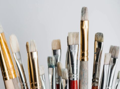various paintbrushes upright silver gold and red accents