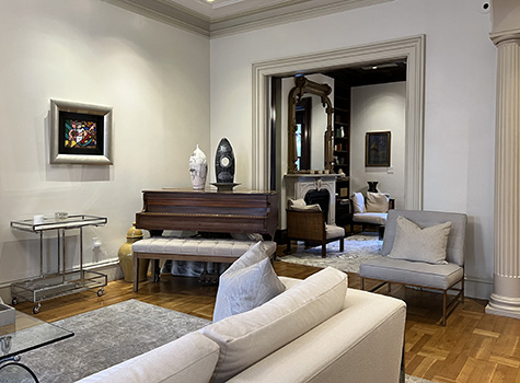 Gray painted Victorian room, white sofa, parquet wood floors, wood grand piano.