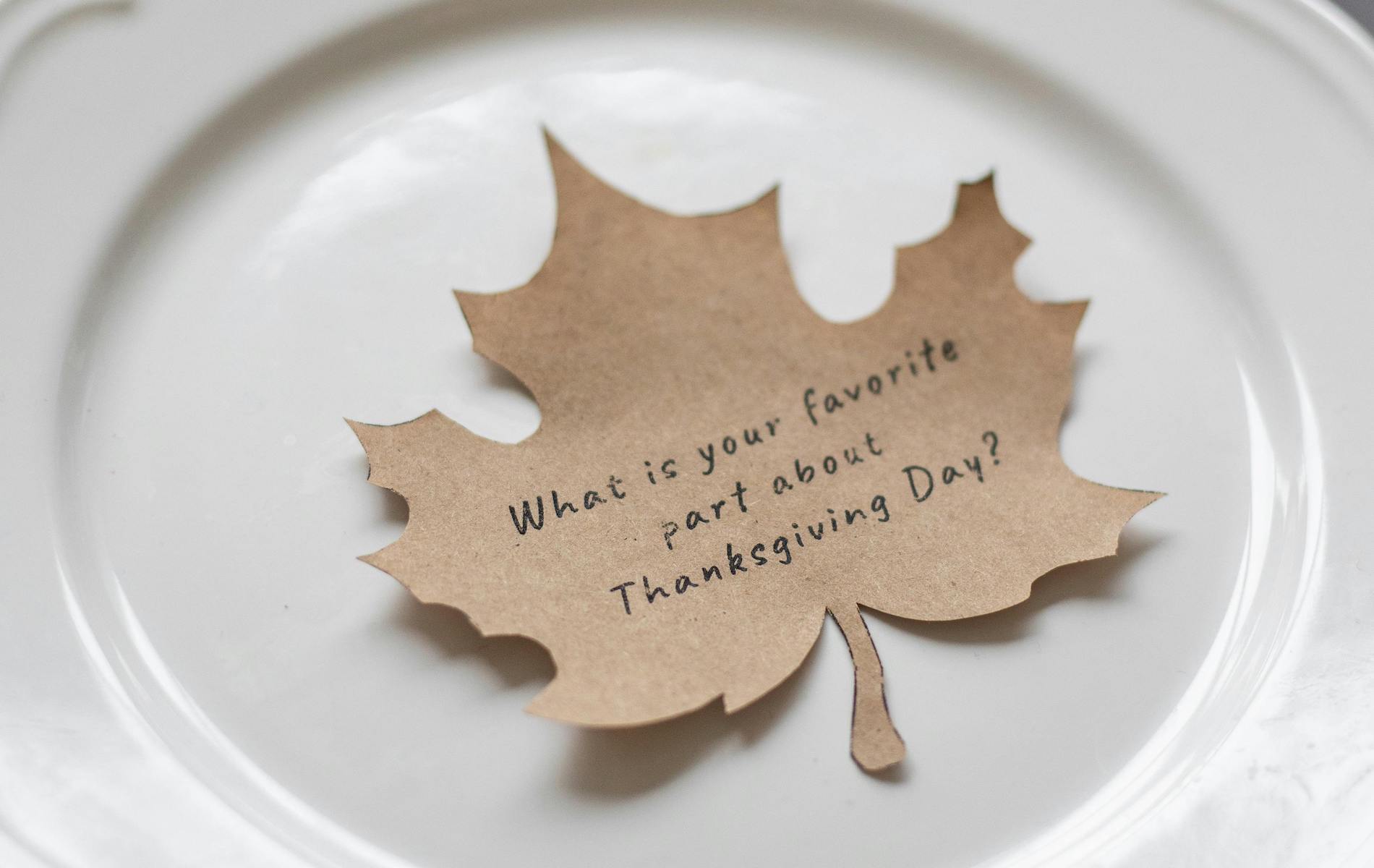 brown leaf on white plate that says what is your favorite part of thanksgiving