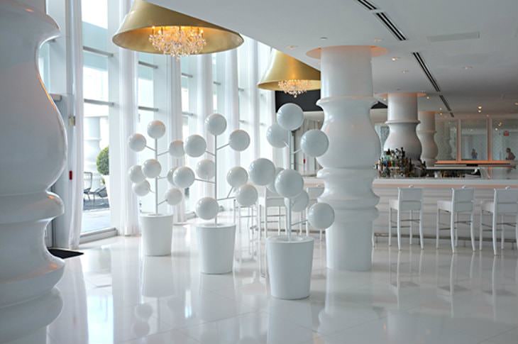 Interior view of a clean, modern, all-white hotel bar area