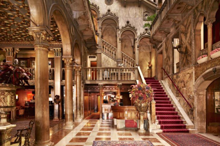 Extravagant hotel lobby in shades of gold and red with luxurious Italian design and decor