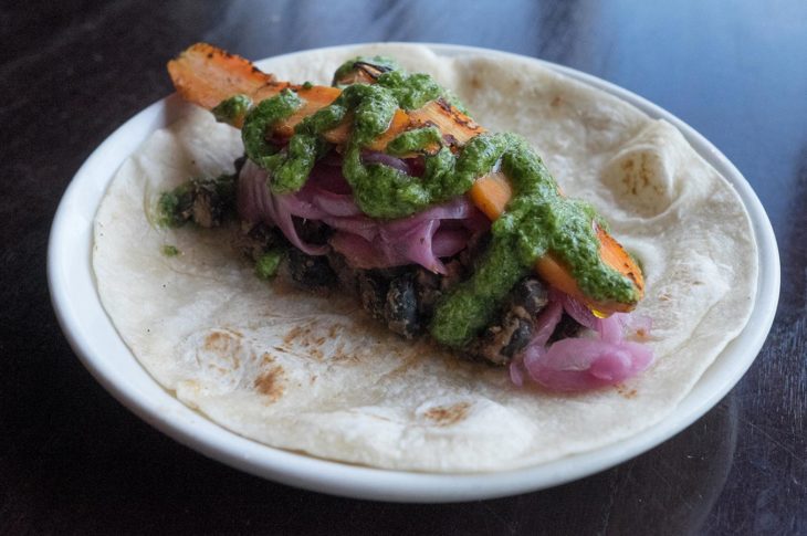 tortilla with purple pickled onions green sauce and grilled steak