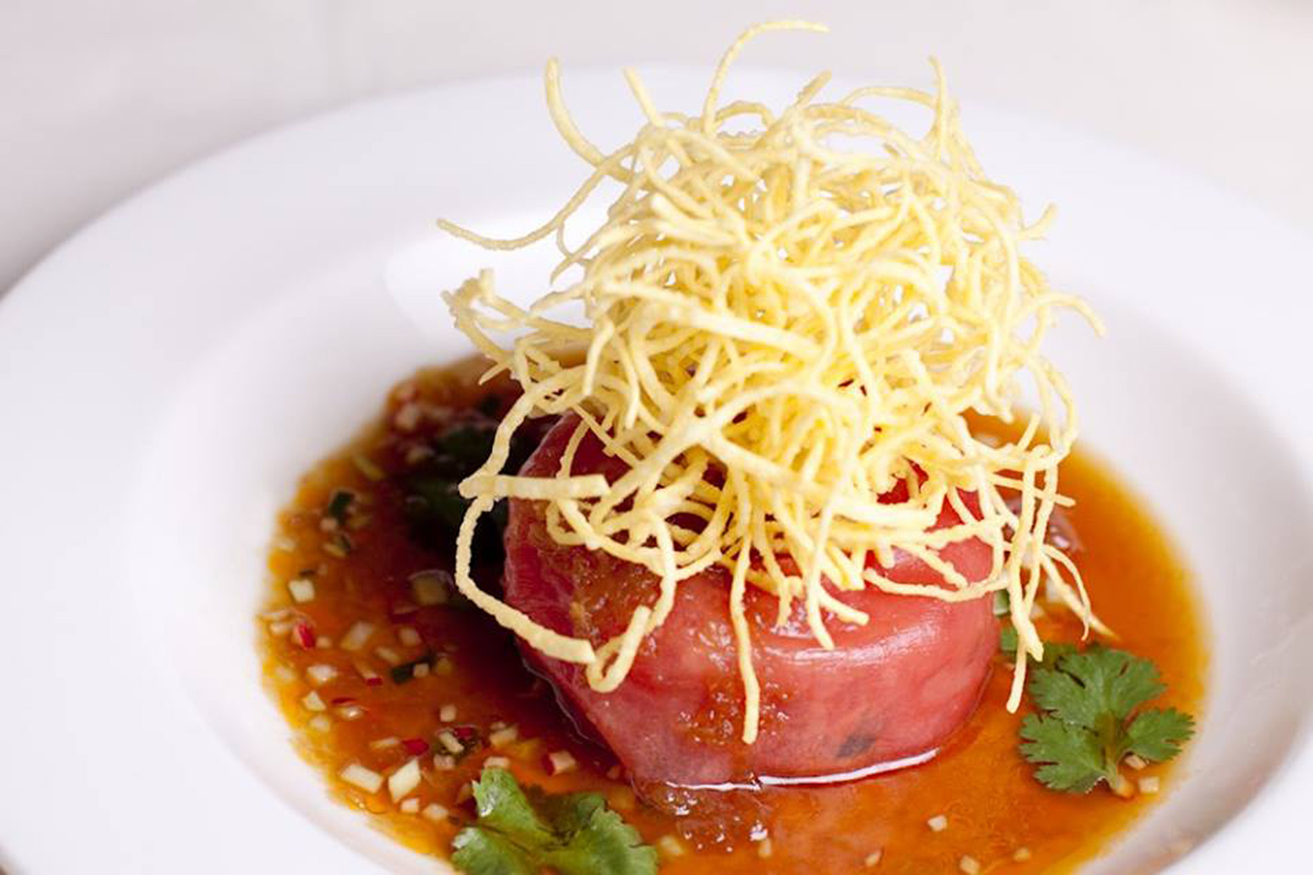 tuna tartare topped with fried onion in soy sauce