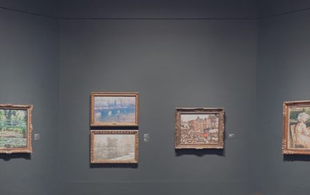 5 framed monet painting on dark grey wall