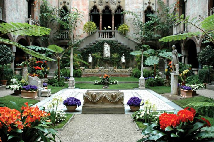 Lush green garden courtyard with red flowers