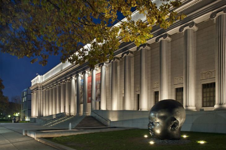 White marble exterior with columns and baby head statue