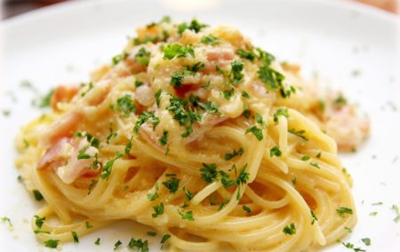 pasta boodles with green parsley on white plate