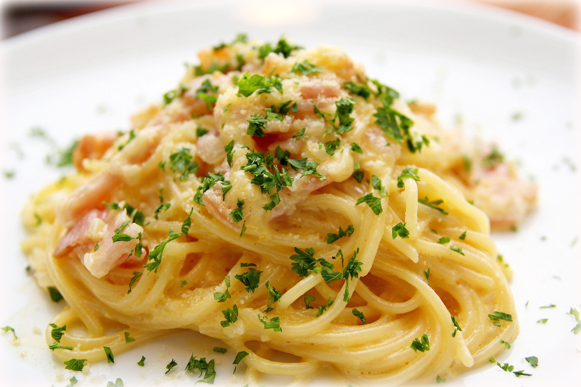 pasta boodles with green parsley on white plate