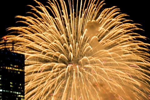 Large burst of gold fireworks against a black sky