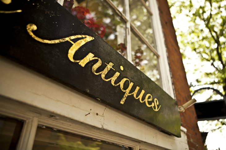 Close-up view of black wooden sign with 